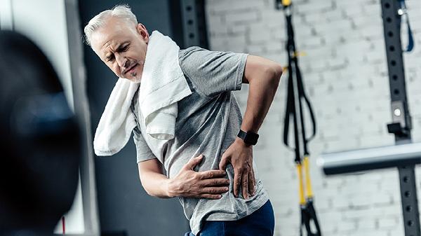 Why does a man experience lower back pain after ejaculation?